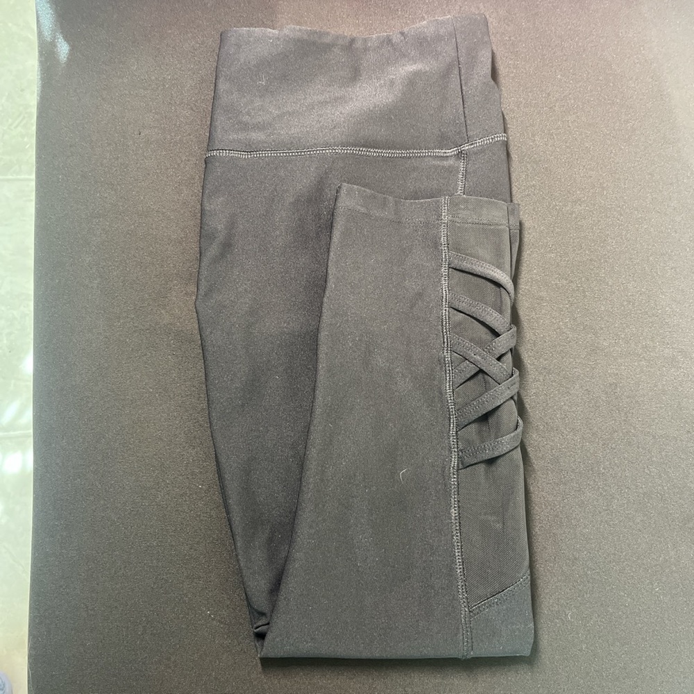 black capri leggings with criss cross design at the bottom by yogo athletics